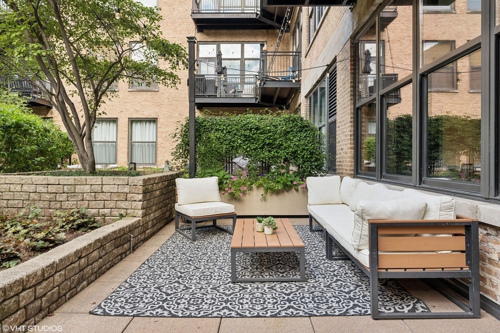 1040 West Adams Street, Unit 308 Chicago, IL 60607 - Photo 36 of 40 a view of a brick house with a large windows