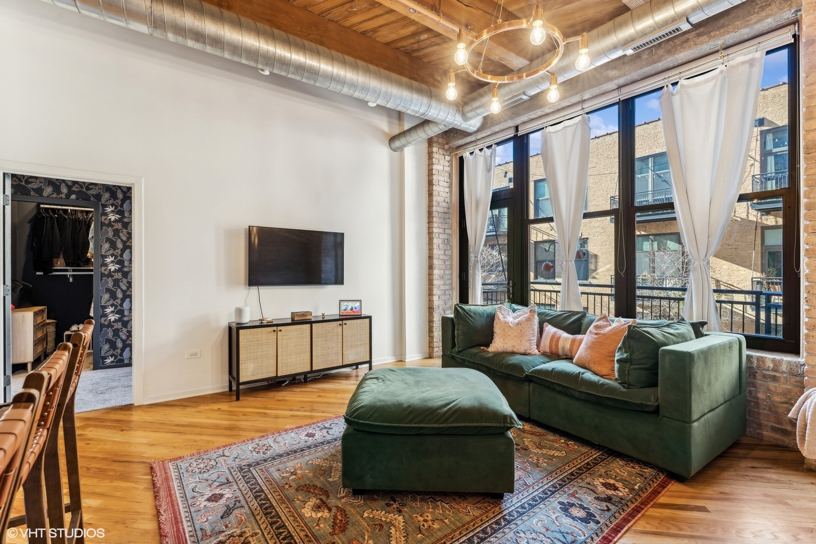 1040 West Adams Street, Unit 308 Chicago, IL 60607 - Photo 5 of 40 a living room with furniture and a flat screen tv