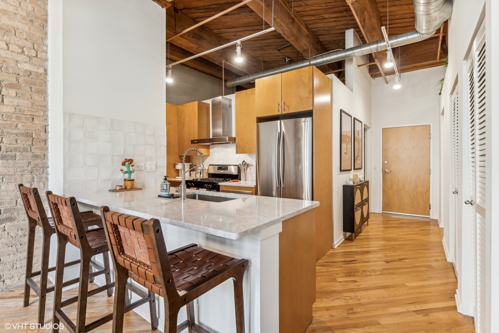 1040 West Adams Street, Unit 308 Chicago, IL 60607 - Photo 8 of 40 a kitchen with stainless steel appliances granite countertop a refrigerator and a stove top oven