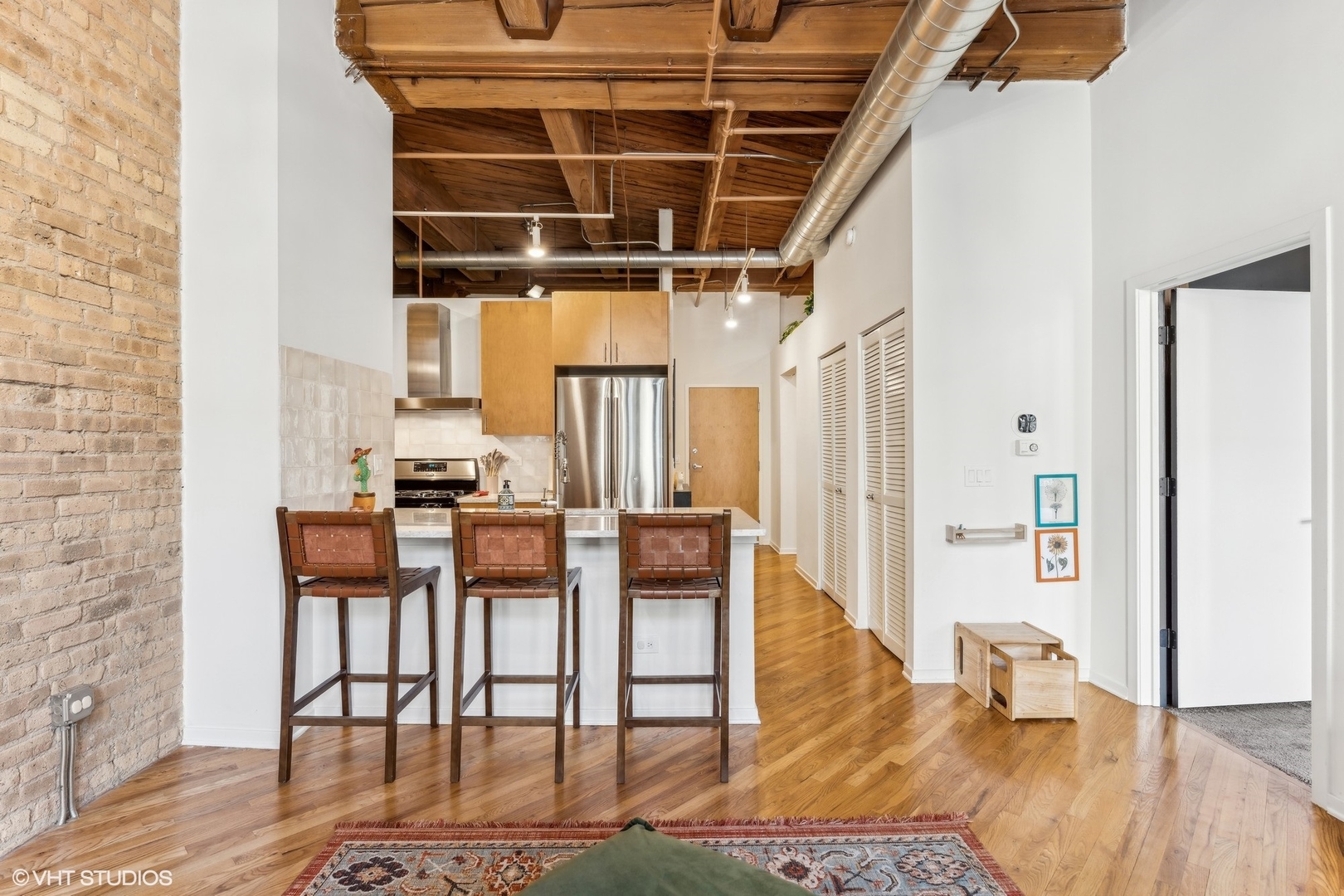 1040 West Adams Street, Unit 308 Chicago, IL 60607 - Photo 9 of 40 a dining room with furniture and wooden floor
