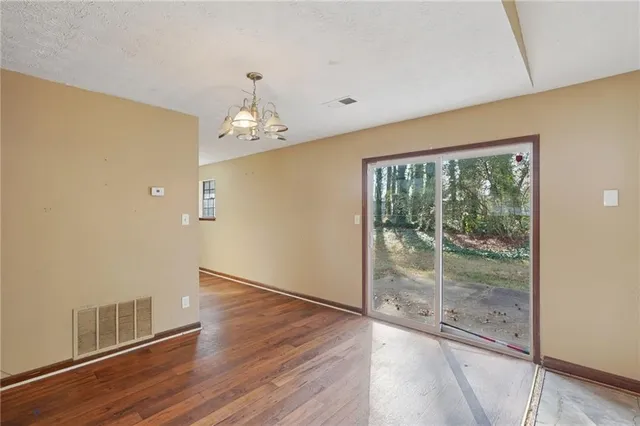 a view of a kitchen with a sink and dishwasher a refrigerator with wooden floor