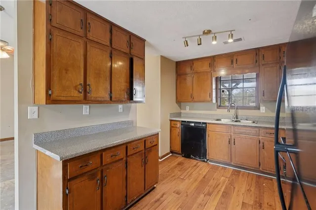 a kitchen with a refrigerator and a sink