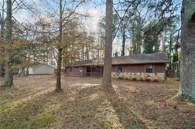 a front view of a house with a tree