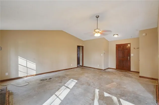 a view of a livingroom with a ceiling fan and window