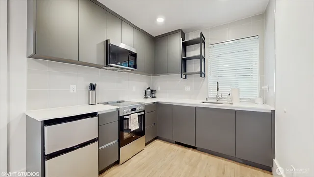 a kitchen with stainless steel appliances stove microwave sink and cabinets