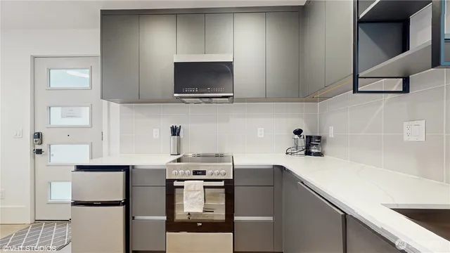a kitchen with stainless steel appliances a sink stove and cabinets