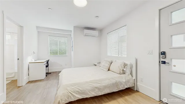 a bedroom with a bed and a window