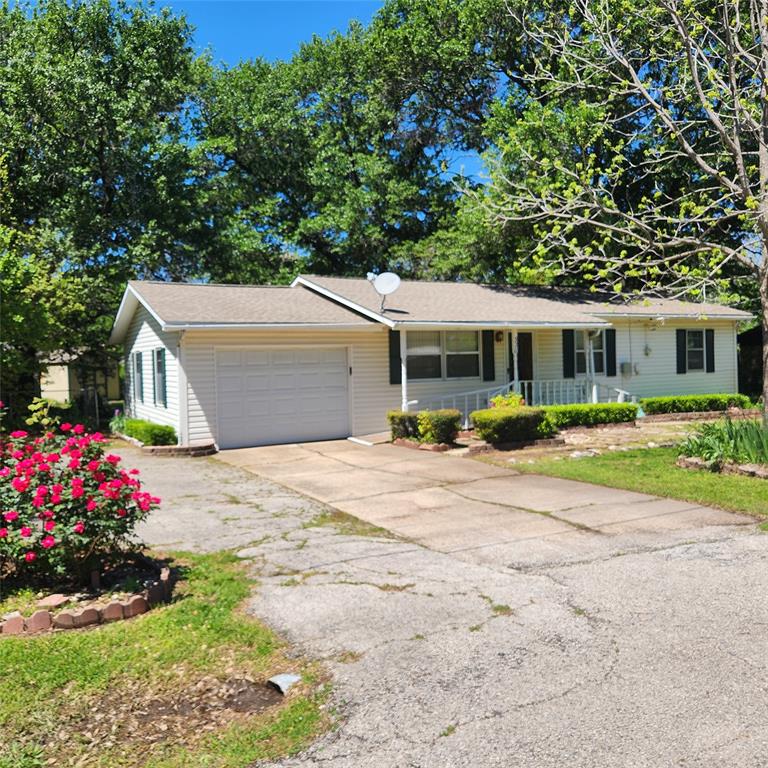 a view of a house with a yard and sitting area