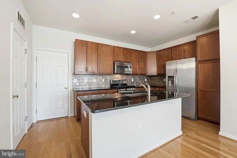 a kitchen with a refrigerator sink and microwave