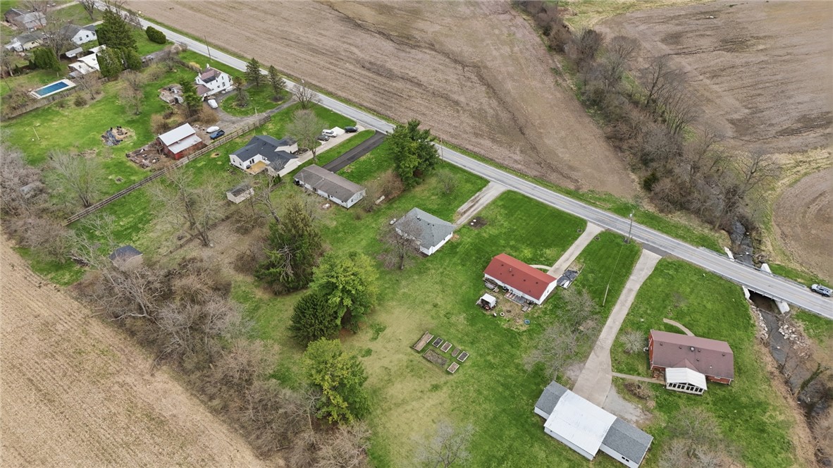 1166 West Sparrow Road Springfield, OH 45502 - Photo 6 of 40 An expansive aerial view captures a vibrant rural landscape with diverse properties.