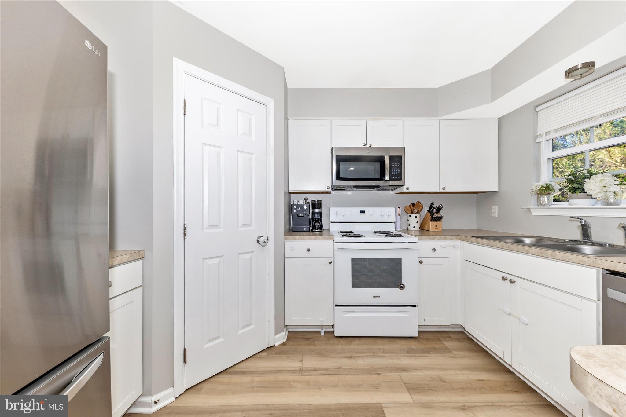 6107 Pine Ridge Terrace Frederick, MD 21701 - Photo 12 of 57 a kitchen with white cabinets and white appliances