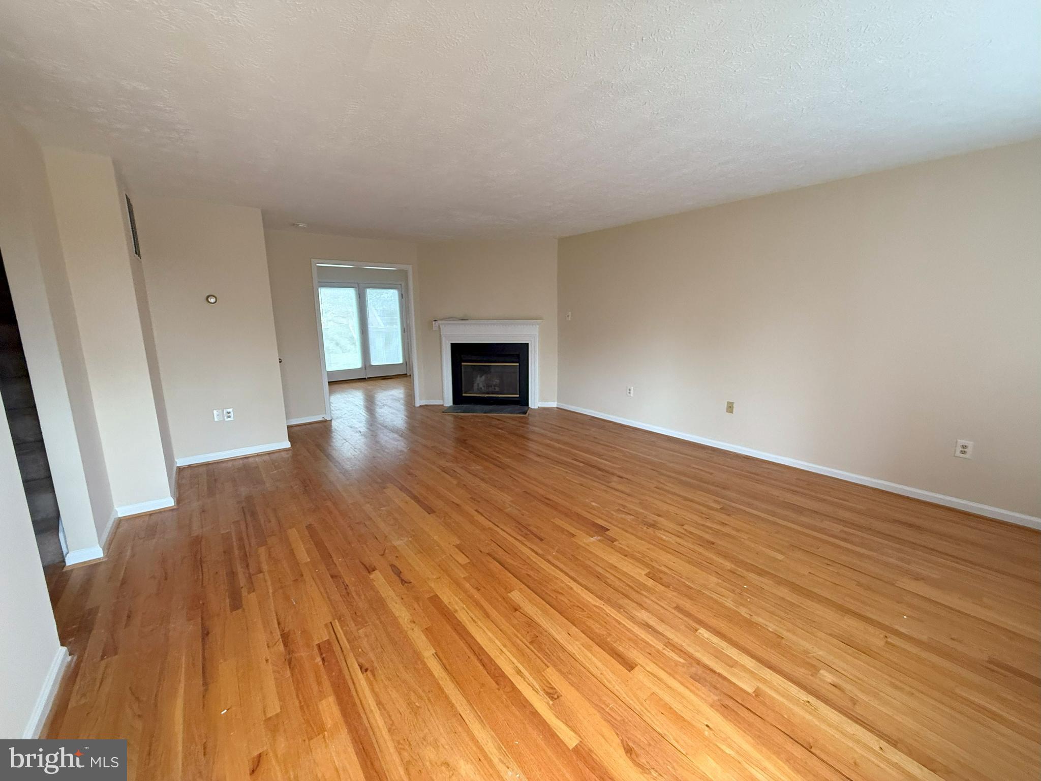 101 Tudor Drive Winchester, VA 22603 - Photo 2 of 13 a view of empty room with wooden floor and fireplace