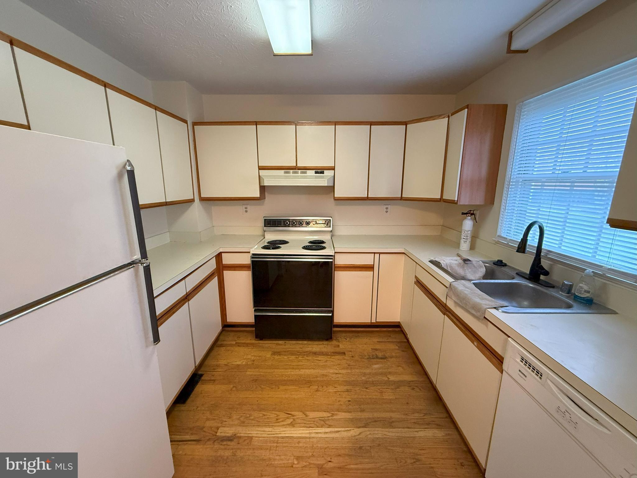 101 Tudor Drive Winchester, VA 22603 - Photo 4 of 13 a kitchen with a sink a stove top oven a refrigerator and cabinets