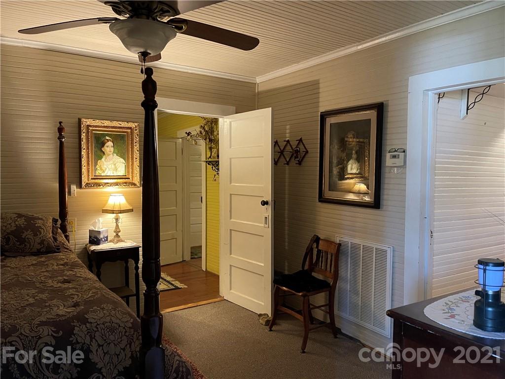 3115 Powe Road Wallace, SC 29596 - Photo 7 of 8 a bedroom with a bed and wooden floor