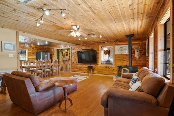 a living room with stainless steel appliances kitchen island a stove and a refrigerator