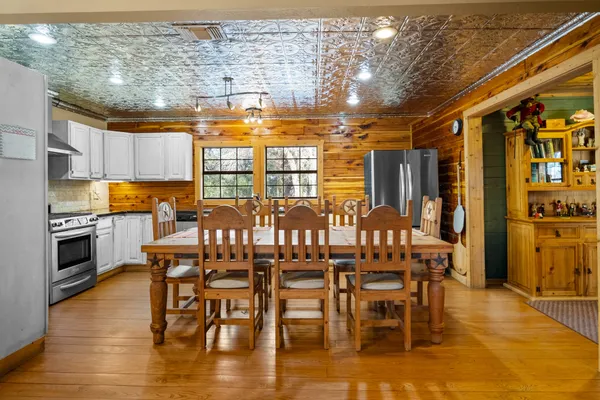 a view of a dining room with furniture wooden floor and chandelier