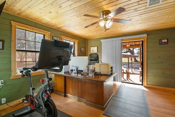 a view of a livingroom with workspace and a window