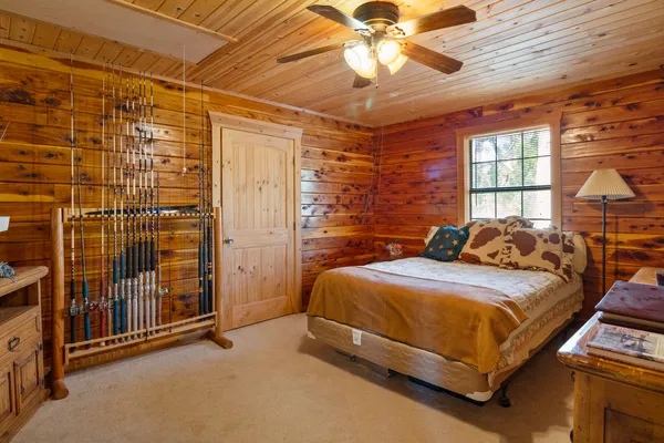 a bedroom with a bed and a chandelier