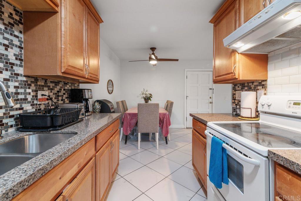 2340 Hosp Way, Unit 120 Carlsbad, CA 92008 - Photo 15 of 33 a kitchen with stainless steel appliances granite countertop a sink dishwasher stove and cabinets