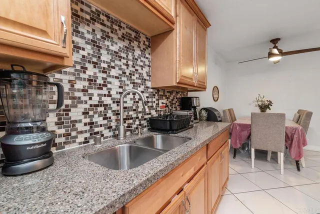 a kitchen with a sink and a stove top oven