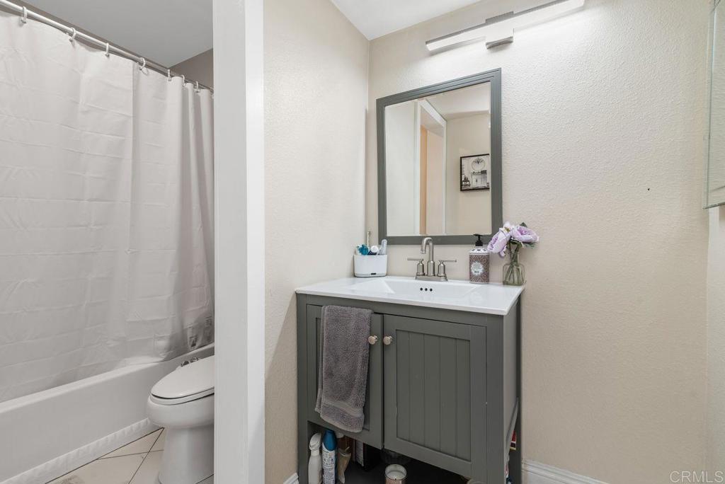 2340 Hosp Way, Unit 120 Carlsbad, CA 92008 - Photo 18 of 33 a bathroom with a sink a toilet and a mirror
