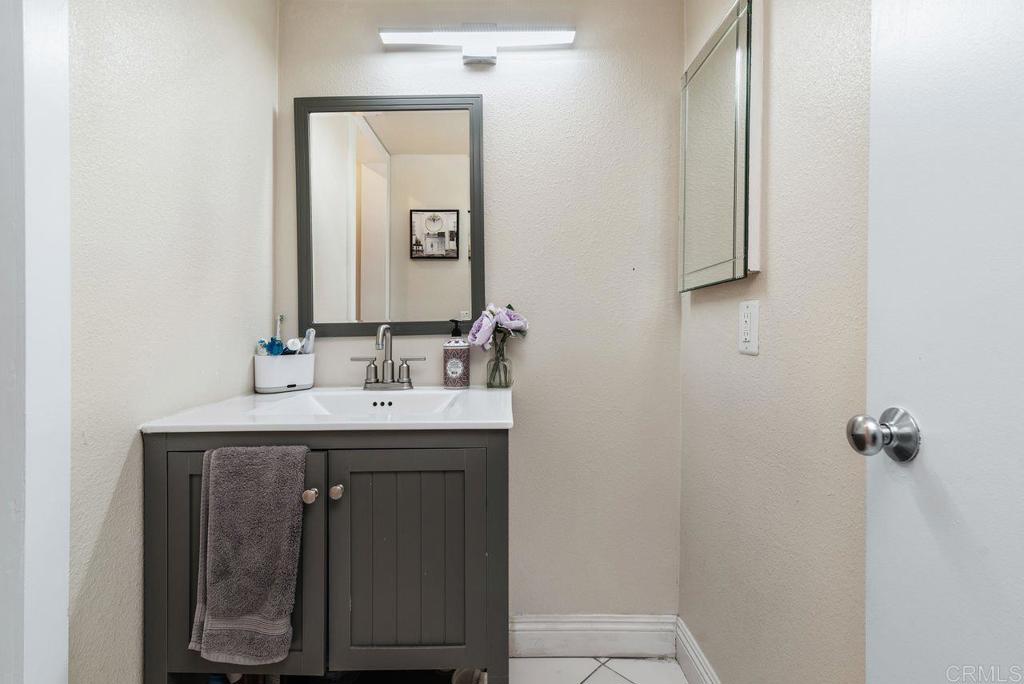 2340 Hosp Way, Unit 120 Carlsbad, CA 92008 - Photo 19 of 33 a bathroom with a sink and a mirror