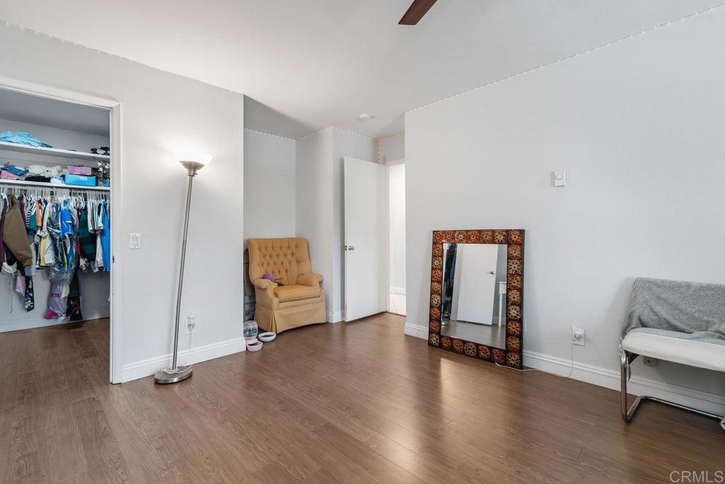 2340 Hosp Way, Unit 120 Carlsbad, CA 92008 - Photo 24 of 33 a view of an empty room with wooden floor and a window