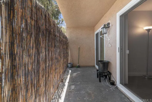 a view of a backyard door with a chair and the door