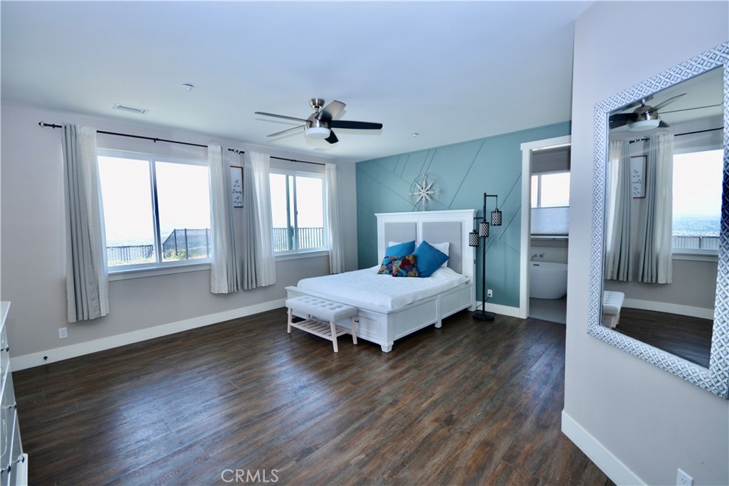 12451 Rancho Heights Road Pala, CA 92059 - Photo 11 of 46 a bedroom with a bed and wooden floor