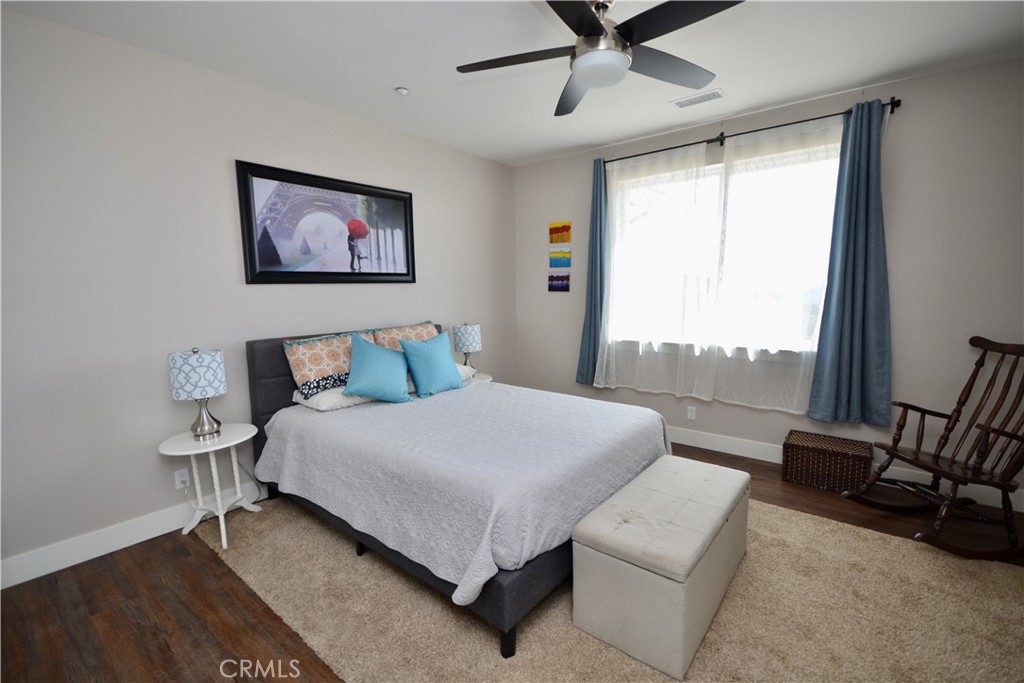12451 Rancho Heights Road Pala, CA 92059 - Photo 15 of 46 a bedroom with a bed couch and window