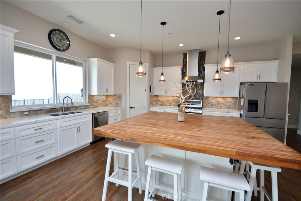 12451 Rancho Heights Road Pala, CA 92059 - Photo 18 of 46 a large kitchen with kitchen island a large island in it