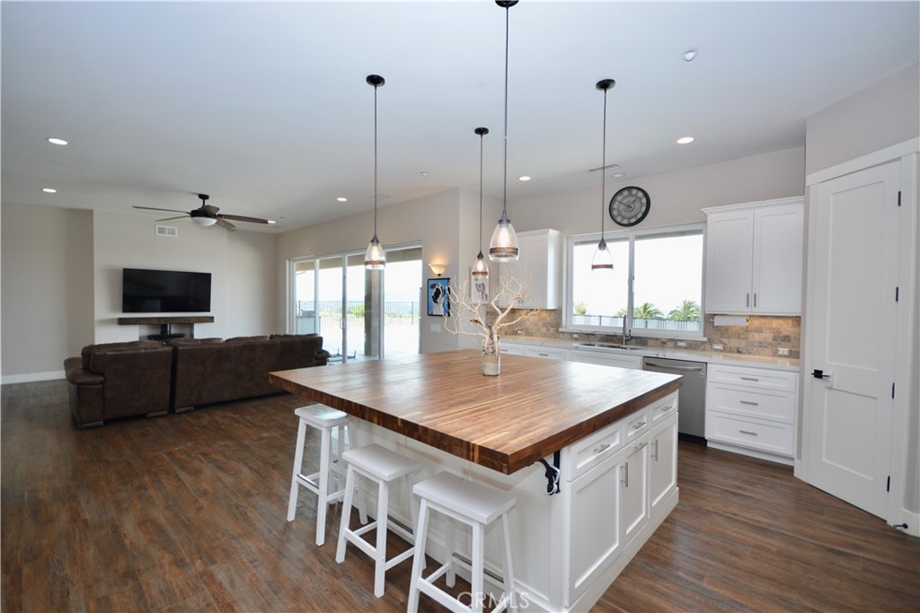 12451 Rancho Heights Road Pala, CA 92059 - Photo 20 of 46 a kitchen with stainless steel appliances granite countertop a stove a sink and a wooden floor