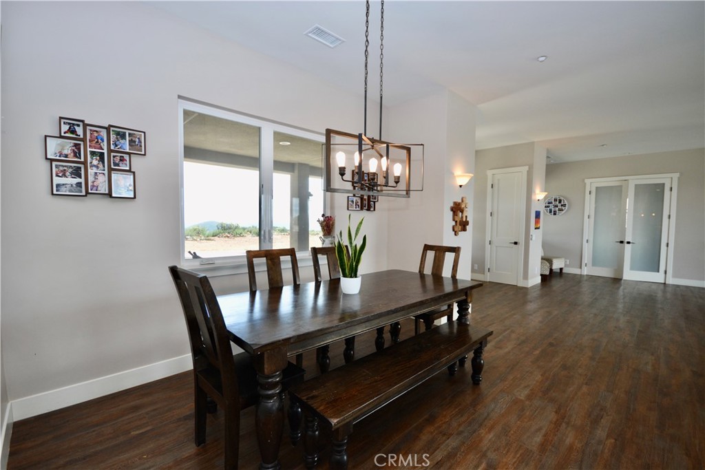 12451 Rancho Heights Road Pala, CA 92059 - Photo 21 of 46 a view of a dining room with furniture and wooden floor