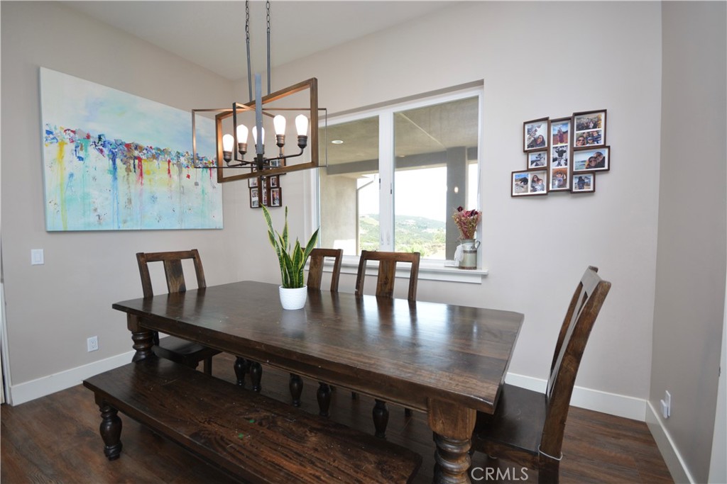 12451 Rancho Heights Road Pala, CA 92059 - Photo 22 of 46 a view of a dining room with furniture a chandelier and wooden floor