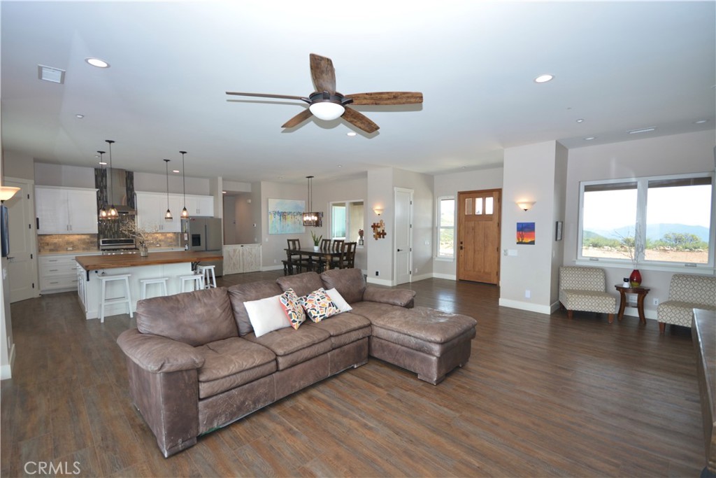 12451 Rancho Heights Road Pala, CA 92059 - Photo 25 of 46 a view of living room kitchen with stainless steel appliances kitchen island hardwood floor and a window
