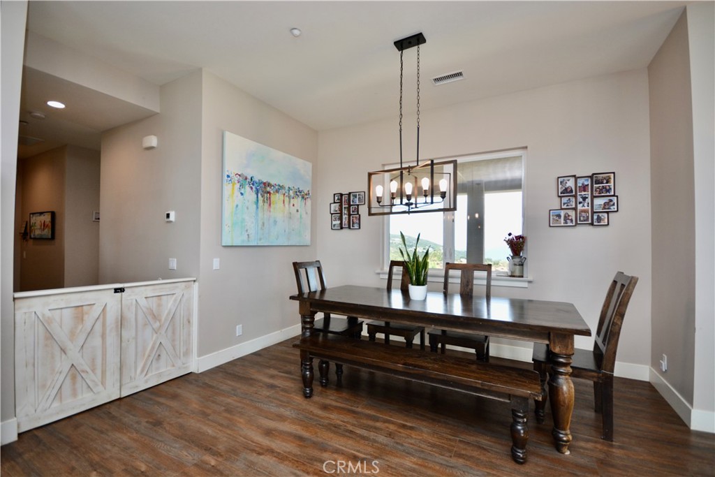 12451 Rancho Heights Road Pala, CA 92059 - Photo 26 of 46 a view of a dining room with furniture window and wooden floor