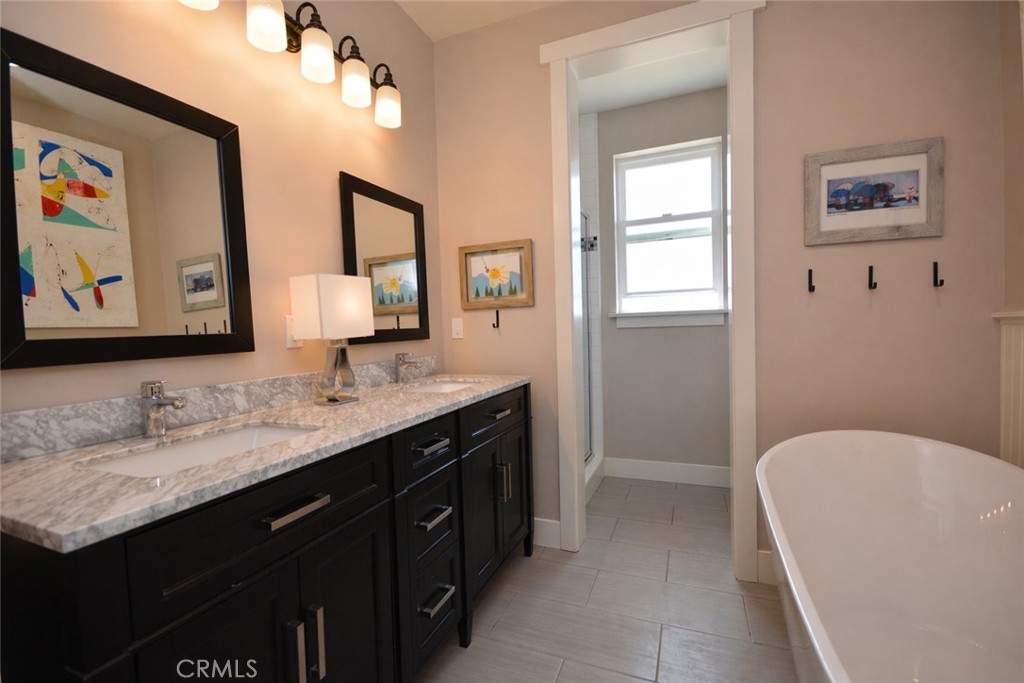 12451 Rancho Heights Road Pala, CA 92059 - Photo 29 of 46 a spacious bathroom with a granite countertop tub sink and mirror