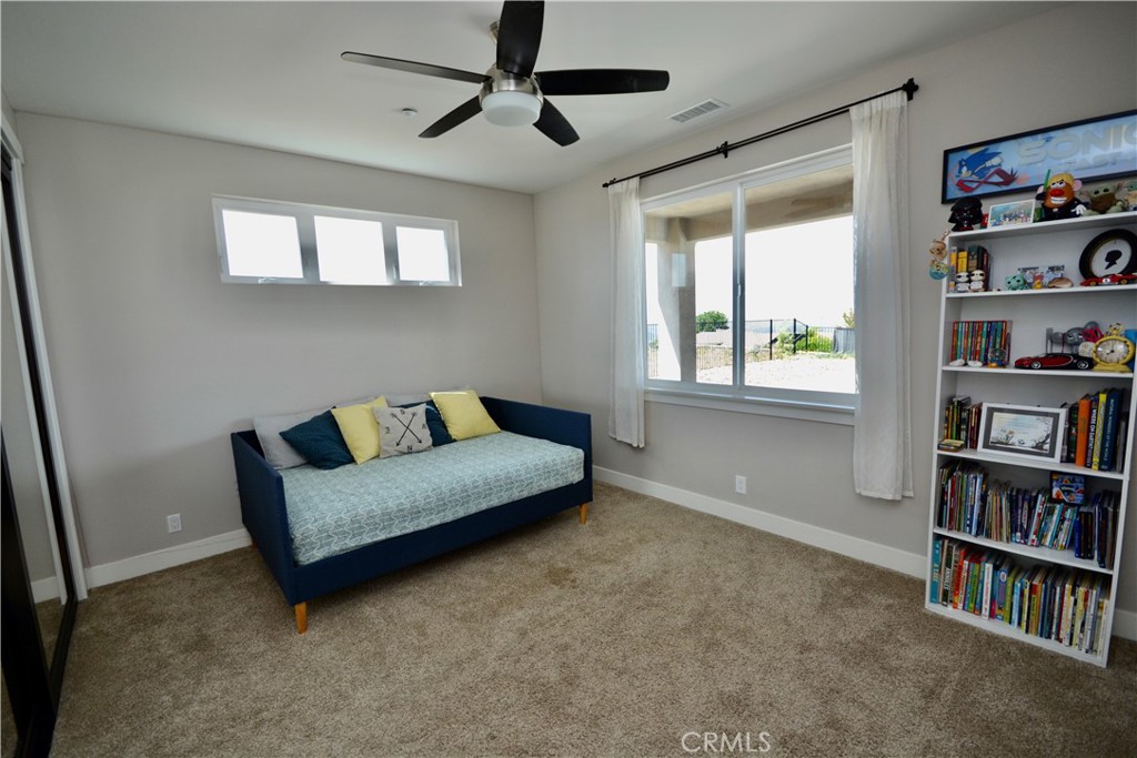 12451 Rancho Heights Road Pala, CA 92059 - Photo 32 of 46 a living room with furniture and a book shelf