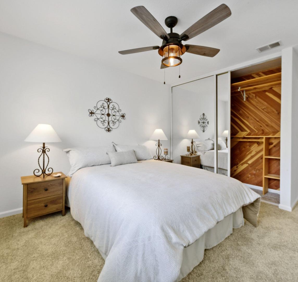 1276 Rosita Road Pacifica, CA 94044 - Photo 7 of 13 a bedroom with a bed and a chandelier