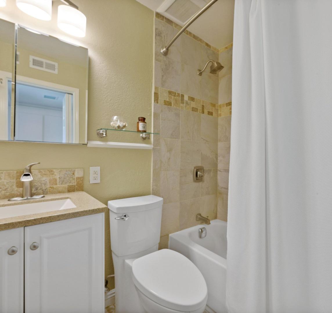 1276 Rosita Road Pacifica, CA 94044 - Photo 10 of 13 a bathroom with a granite countertop sink toilet and shower