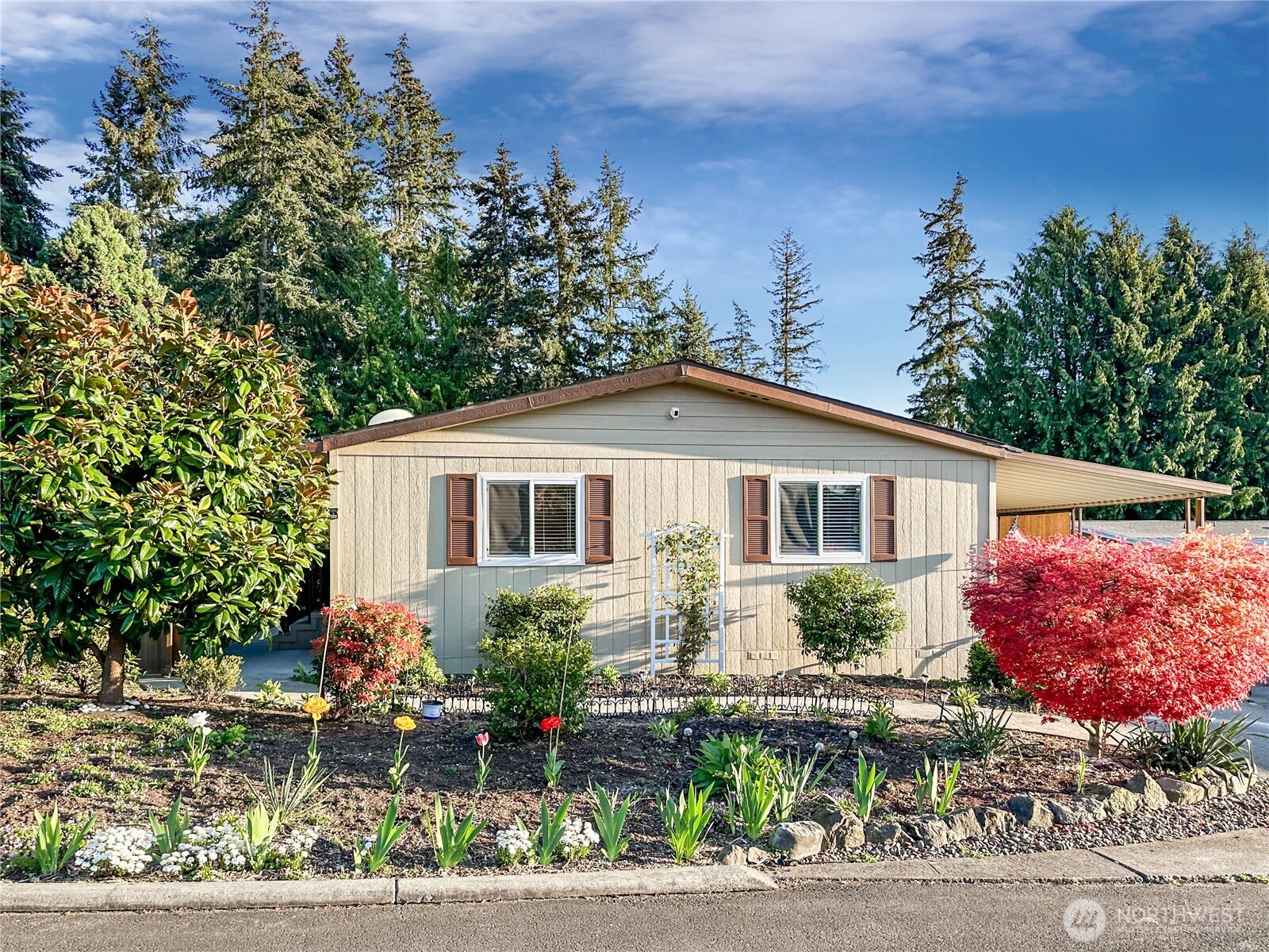 a front view of a house with plants