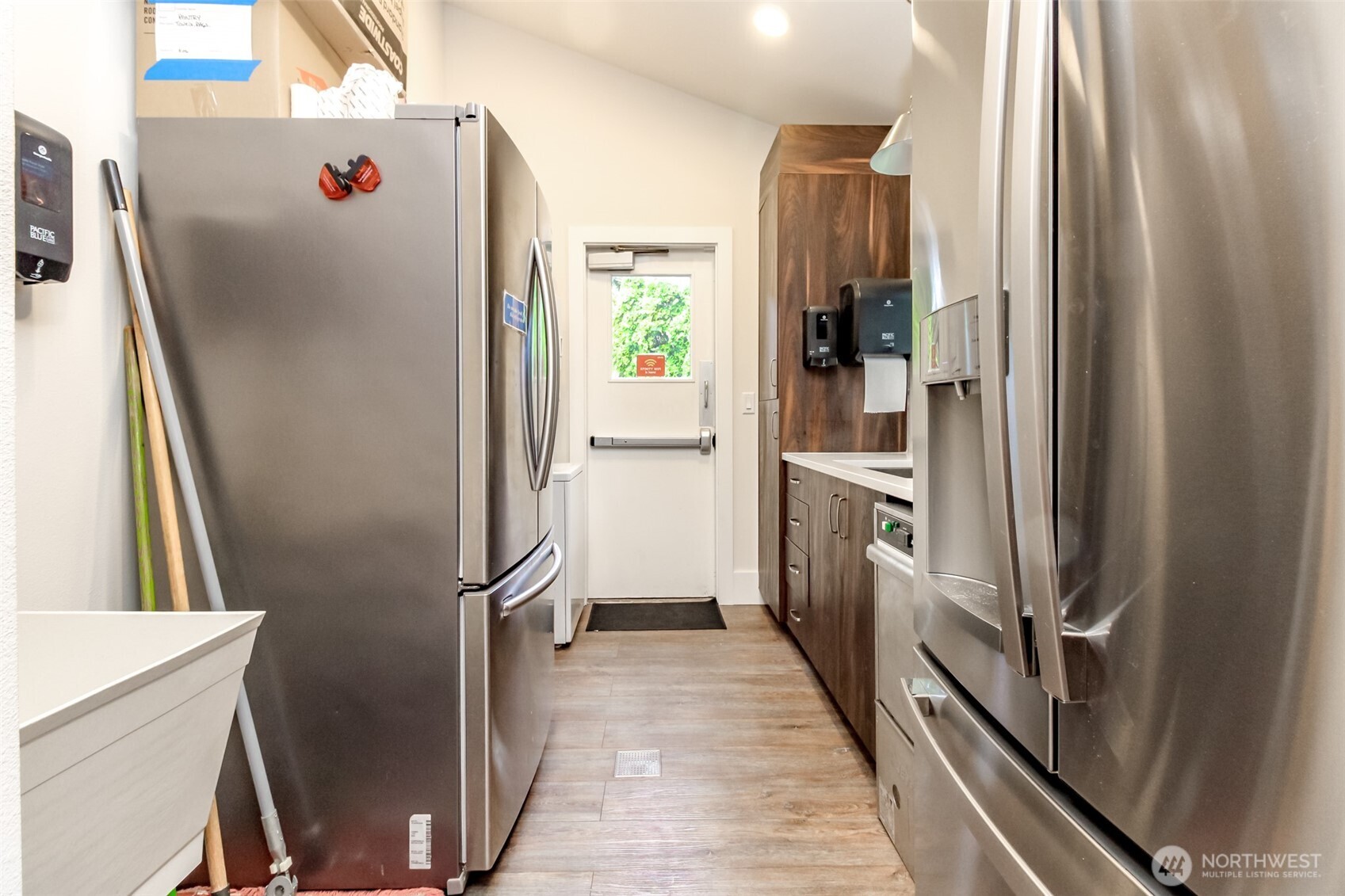 2500 South 370th Street, Unit 54 Federal Way, WA 98003 - Photo 29 of 40 a view of a kitchen with fridge and wooden floor