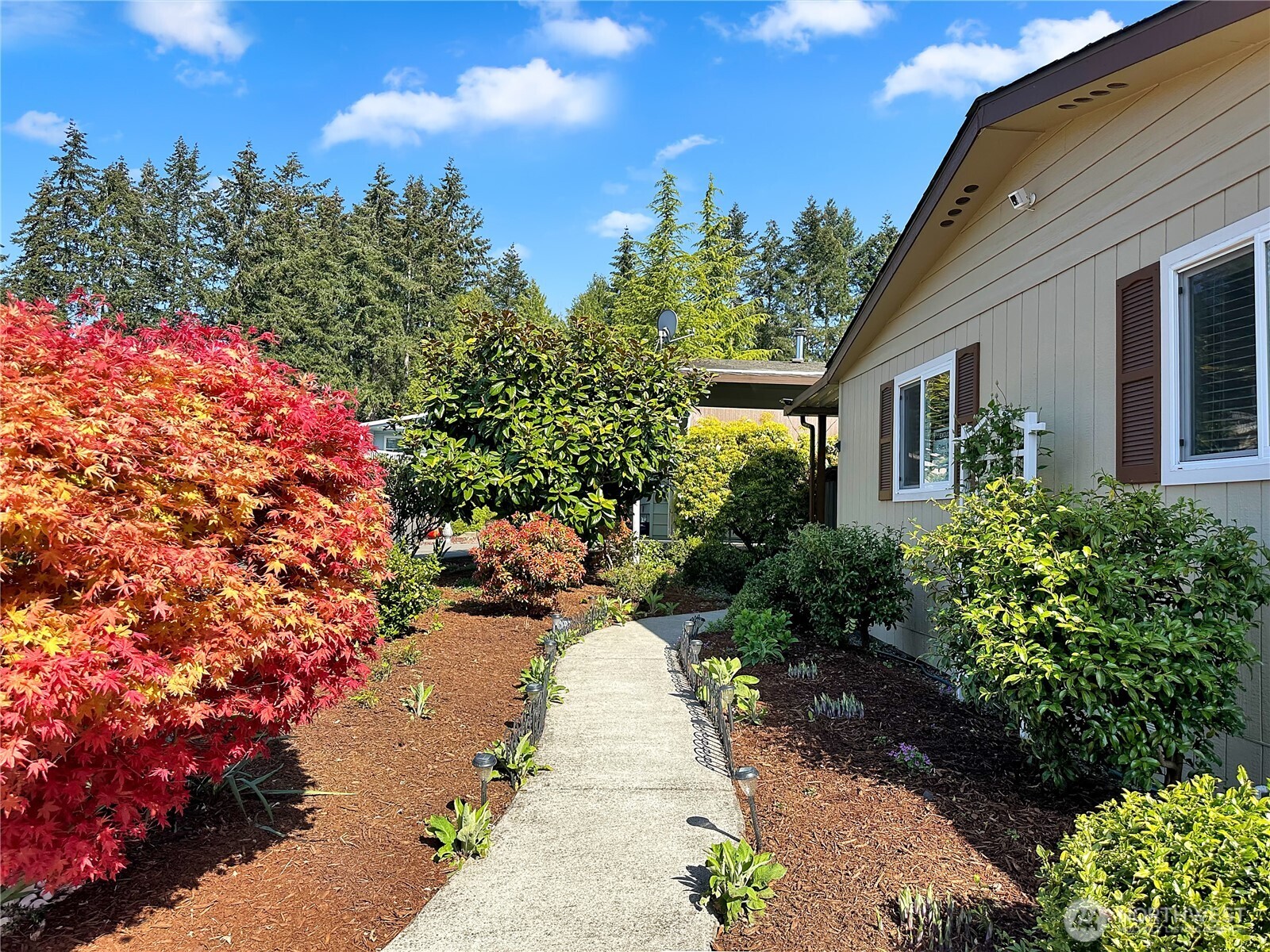 2500 South 370th Street, Unit 54 Federal Way, WA 98003 - Photo 3 of 40 a view of a pathway with a flower garden