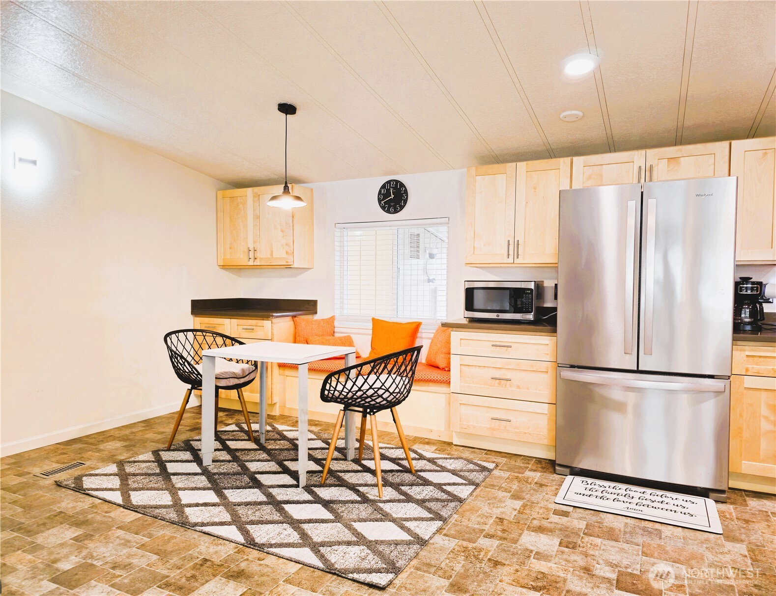 2500 South 370th Street, Unit 54 Federal Way, WA 98003 - Photo 8 of 40 a kitchen with stainless steel appliances kitchen island granite countertop a refrigerator a stove a microwave oven with white cabinets and wooden floor