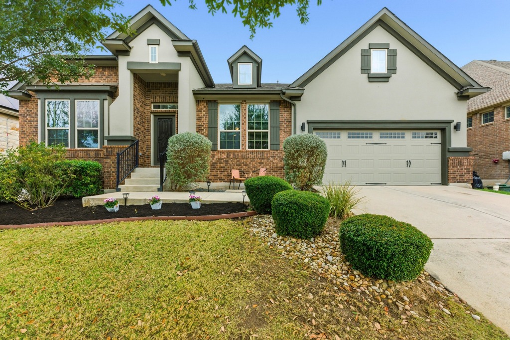 5425 Cherokee Draw Road Austin, TX 78738 - Photo 1 of 40 A well-maintained facade features brick and stucco accents, offering a pleasing first impression.