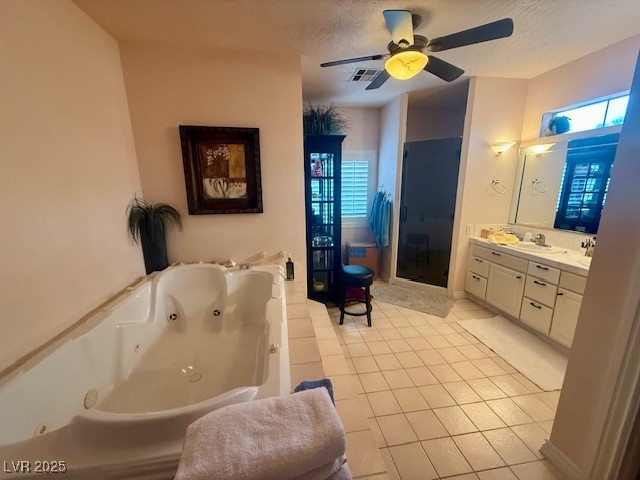 10561 Rancho Destino Road Las Vegas, NV 89183 - Photo 17 of 29 Bathroom featuring a shower stall, a ceiling fan, tile patterned floors, vanity, and a whirlpool tub