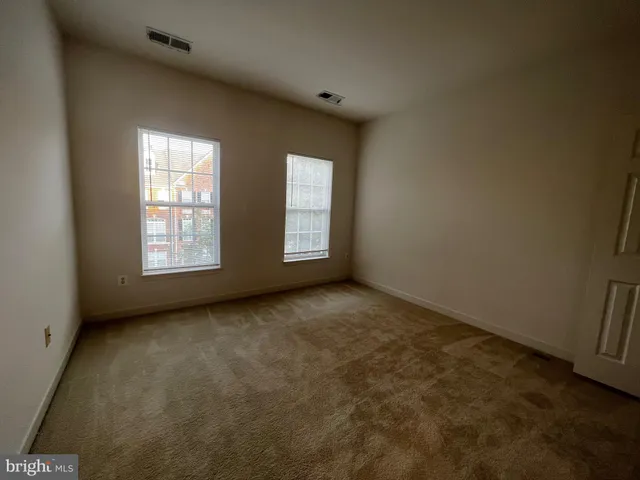 a spacious bathroom with a sink and a mirror