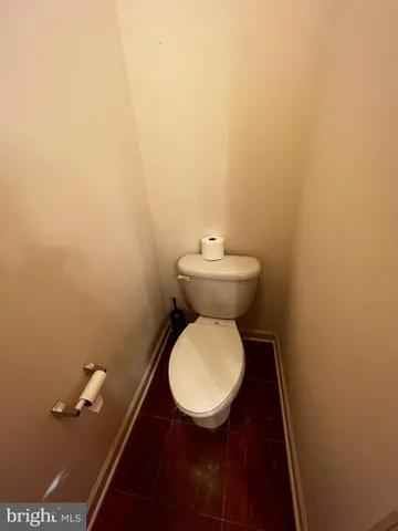 a white toilet sitting next to a bathroom sink