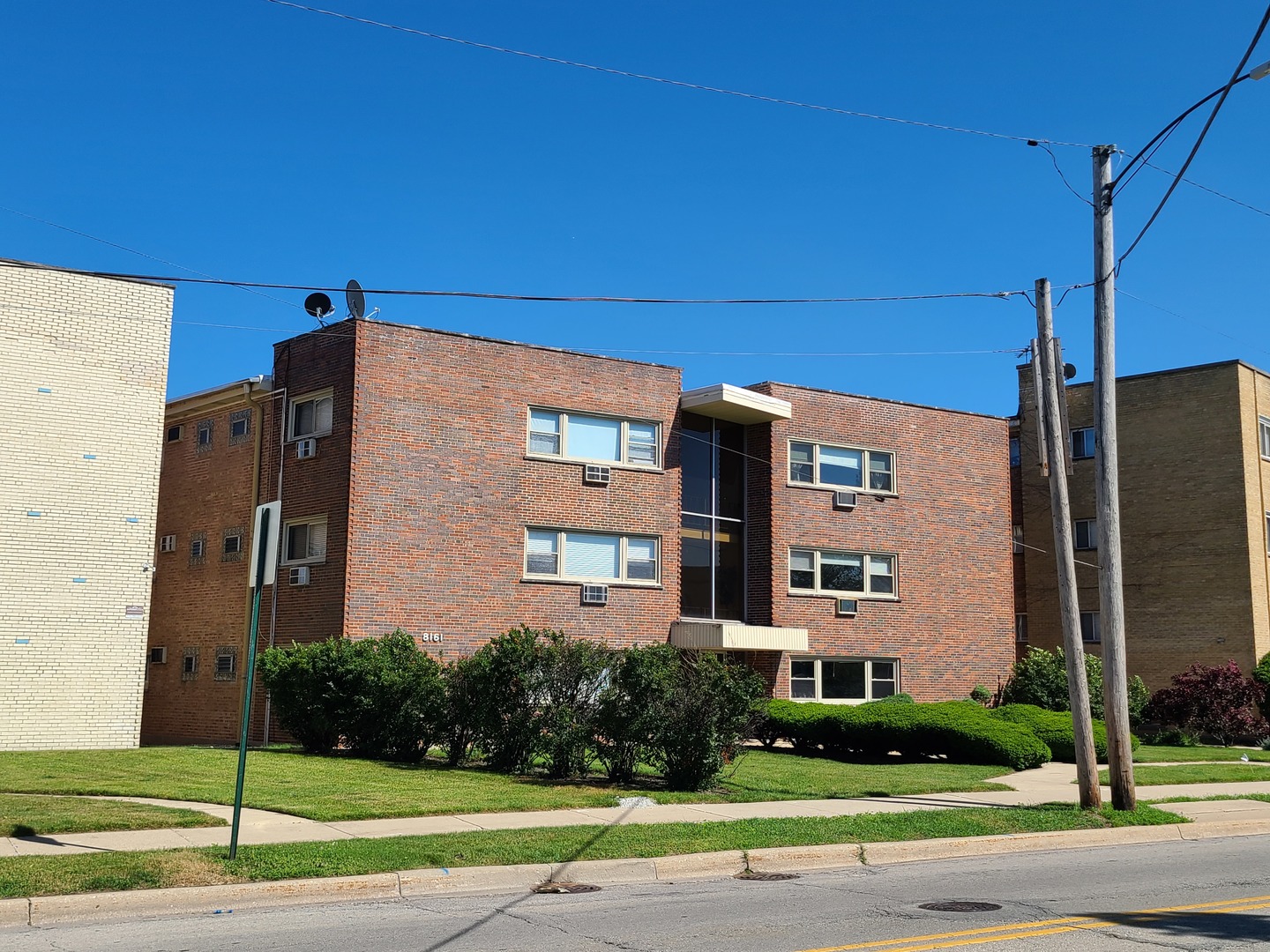 8161 Niles Center Road, Unit 2D Skokie, IL 60077 - Photo 3 of 23 a view of a building with a yard