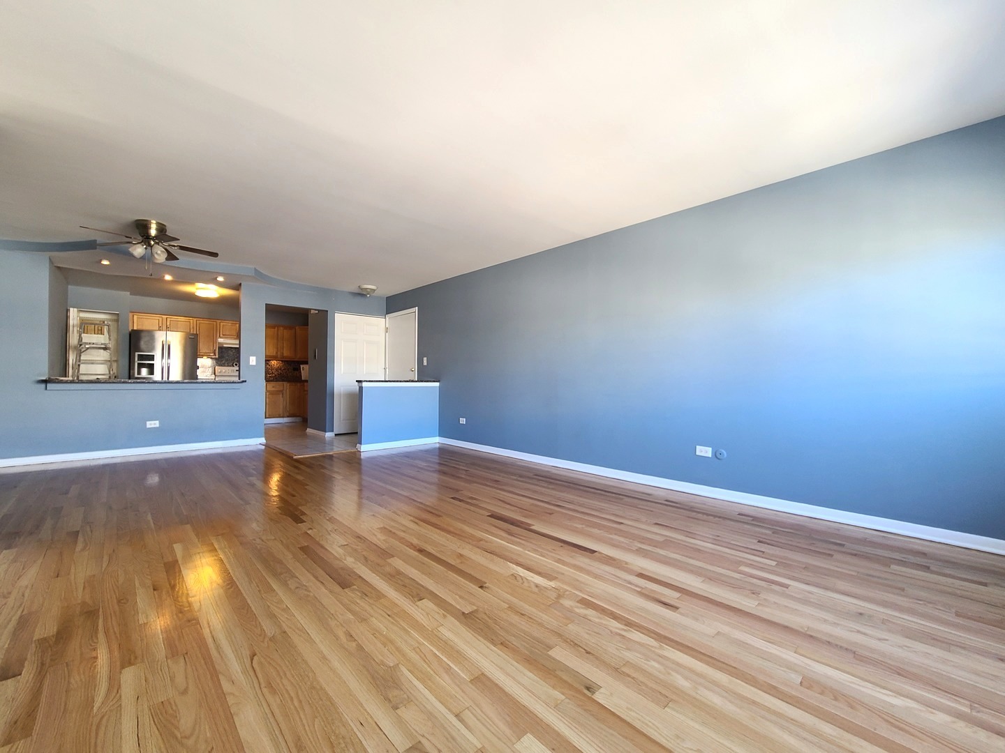 8161 Niles Center Road, Unit 2D Skokie, IL 60077 - Photo 6 of 23 wooden floor in an empty room with a window